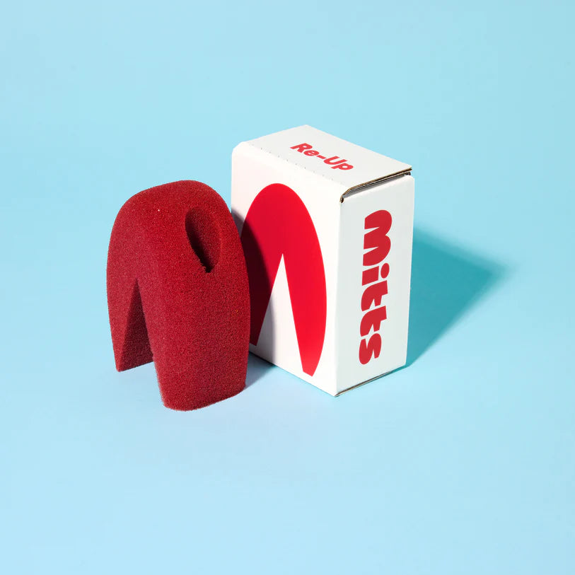 Red sponge with packaging labeled 'Mitts' on a light blue background