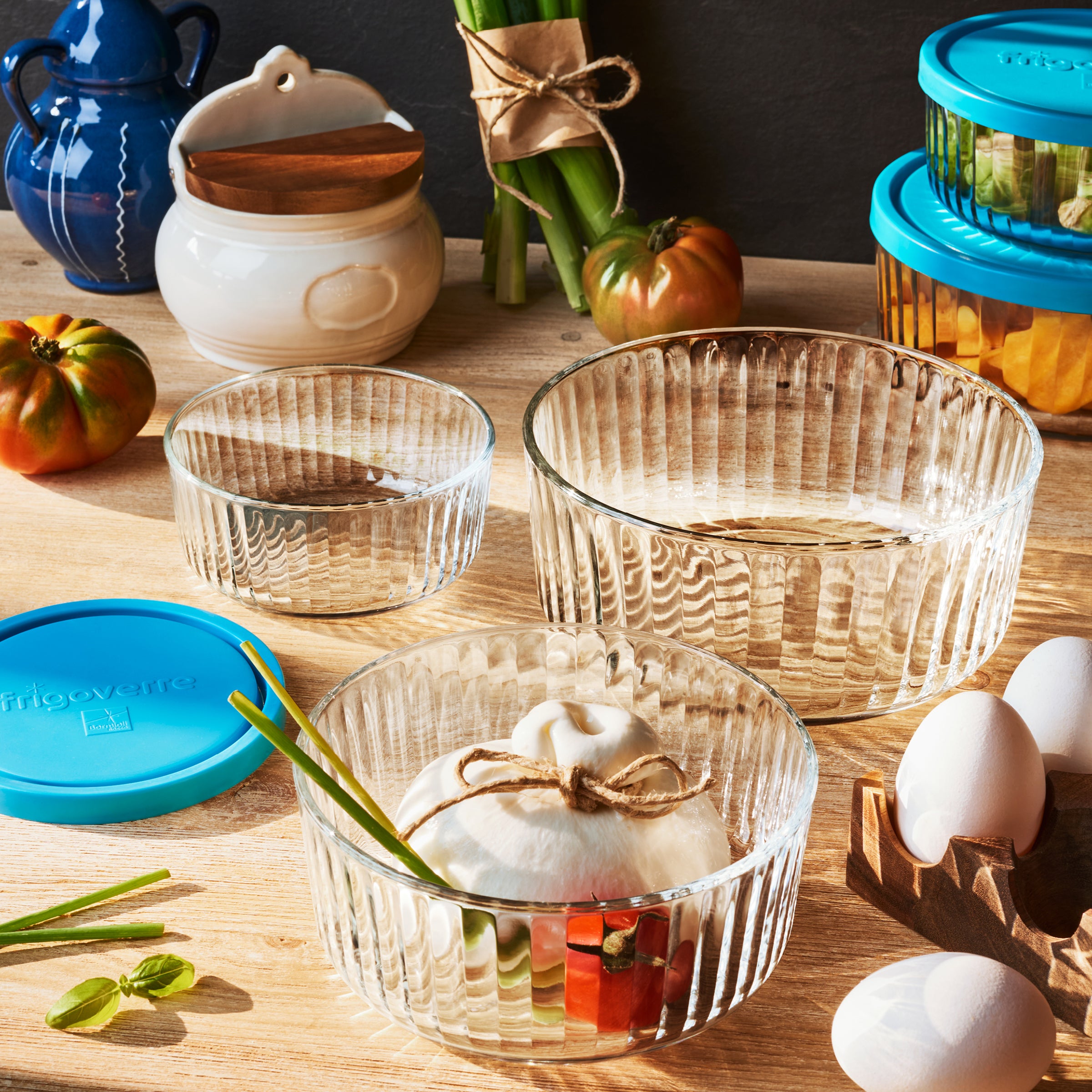 Clear Brilliante glass bowls with decorative items on a wooden table.
